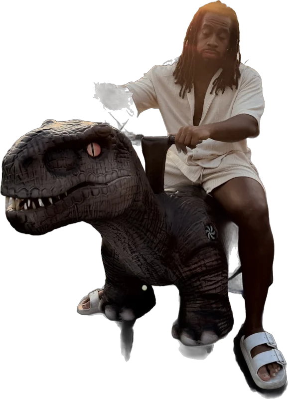 Quan riding a dinosaur ride at sunset